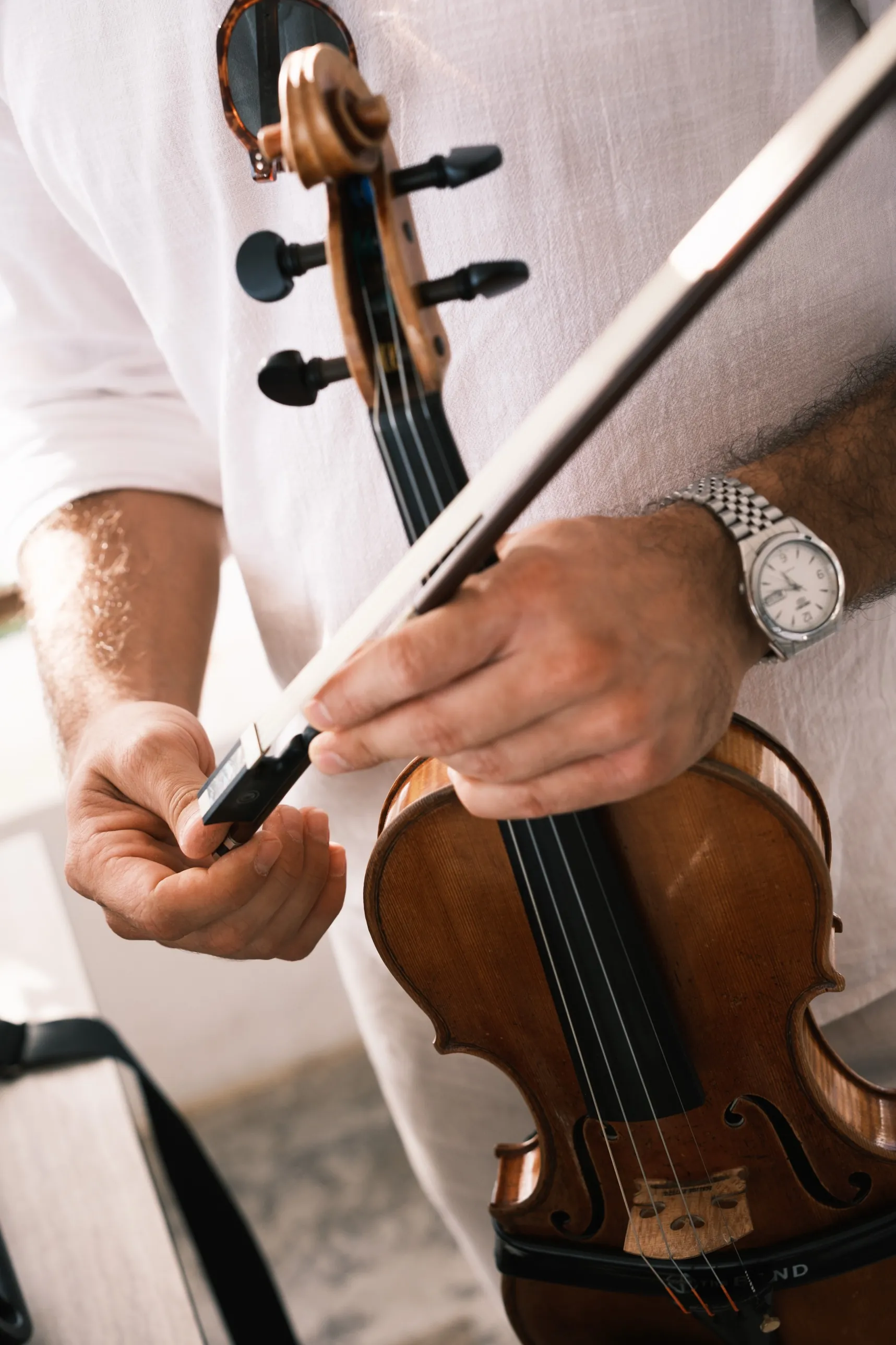 Close-up of Marios’s hands on the violin and bow